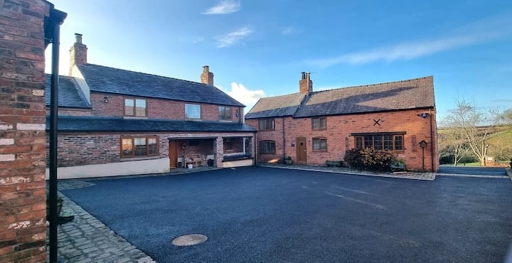 The farmyard at Hill Farm, the farmhouse and converted barns around the open courtyard