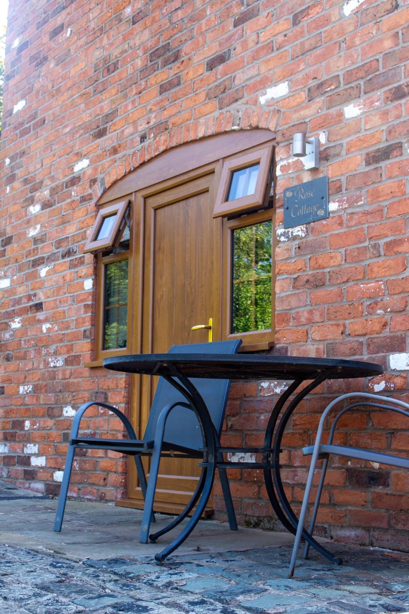 Morning light on an oak door and the table set outside it