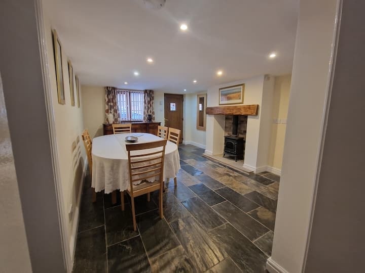 The dining room, laid for a meal on a slate-tiled floor