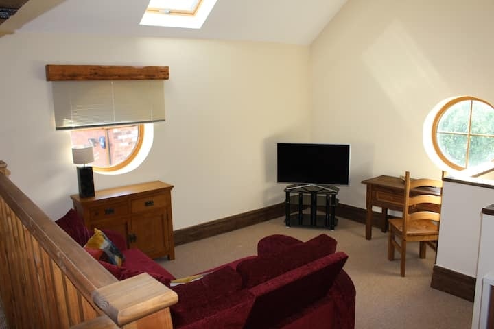 The living room at Rose Cottage beneath its beamed roof
