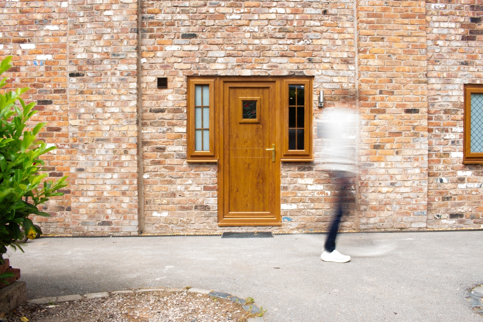 The oak front door of The Gate House in its red-brick wall