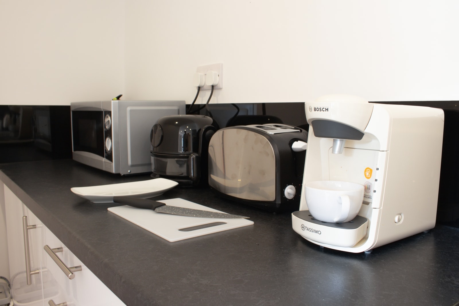 The worktop set up for breakfast, with toaster, kettle and coffee machine