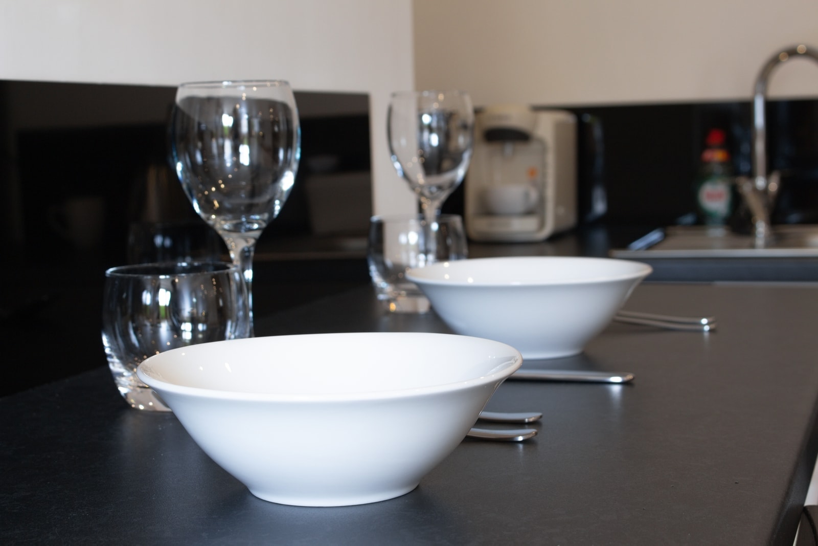 The breakfast bar laid with wine glasses and bowls