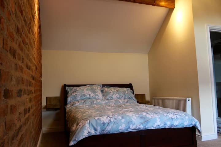 The double bedroom under the eaves, made up in blue