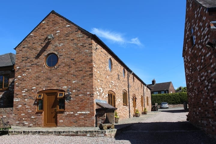 The row of converted brick barns along the farm courtyard