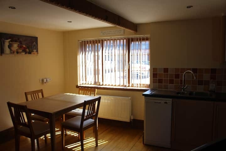 The dining table set beneath the window