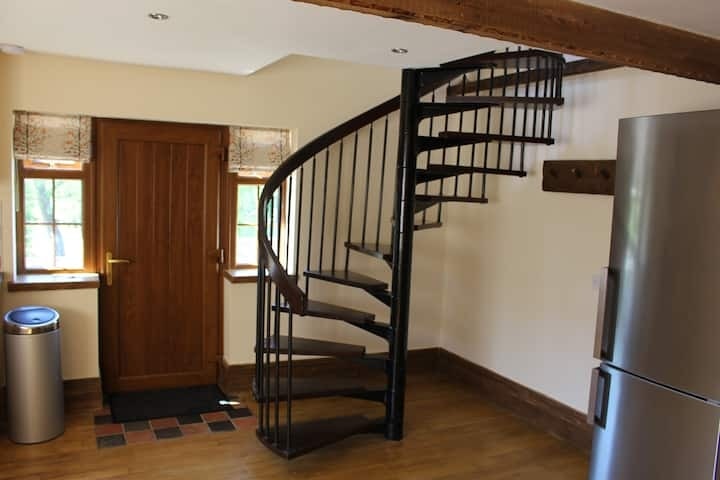 The black spiral staircase turning up to the mezzanine