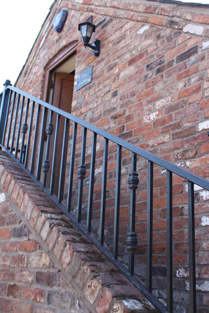 The stone steps rising against the old brickwork
