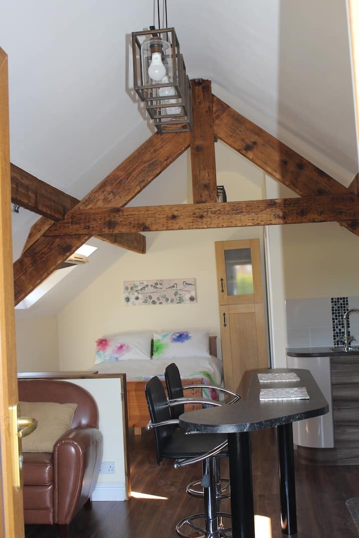 The bedroom under the eaves, looking through to the kitchen