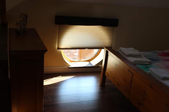 The round window above the desk, catching the afternoon light
